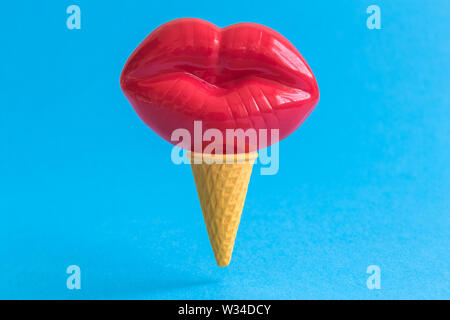 Eis mit roten Lippen gegen Pastell-blaue Hintergrund wenig Süßes essen und Liebe kreatives Konzept. Stockfoto