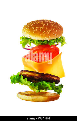 Flying Zutaten für einen hausgemachten Burger. Nicht Diät essen, ungesundes Essen. Auf weiß Isoliert Stockfoto