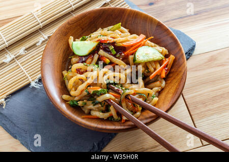 Wokgemüse kimchi Udon Noodle bokkeum mit frischen Kirby Gurken Karotten und gochujang suace Stockfoto