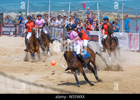 Sandbänke, Poole, Dorset, Großbritannien, 12. Juli 2019. Die Sandpolo britische Beach Polo Meisterschaften erhält unterwegs bei Sandbanks Beach, Poole an einem warmen sonnigen Tag. Der größte Strand Polo Event in der Welt, die zweitägige Veranstaltung findet am Freitag und Samstag statt, die Besucher des Beach Head der Aktion zu sehen. Credit: Carolyn Jenkins/Alamy leben Nachrichten Stockfoto