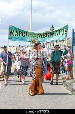 Brighton UK 13. Juli 2019 - Der März der Meerjungfrauen Parade macht seinen Weg entlang der Küste von Brighton in heißen, sonnigen Wetter heute. Der März der Meerjungfrauen Parade in Brighton war die erste Veranstaltung dieser Art in Großbritannien, im Jahr 2012 erstellte und vom Coney Island Mermaid Parade in New York inspiriert und ist eine Feier unserer Meere und Sea Life, Sensibilisierung für die Bedeutung der Erhaltung der Meere. Foto: Simon Dack/Alamy leben Nachrichten Stockfoto