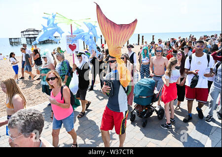 Brighton UK 13. Juli 2019 - Der März der Meerjungfrauen macht seinen Weg entlang der Küste von Brighton in heißen, sonnigen Wetter heute. Der März der Meerjungfrauen Parade in Brighton war die erste Veranstaltung dieser Art in Großbritannien, im Jahr 2012 erstellte und vom Coney Island Mermaid Parade in New York inspiriert und ist eine Feier unserer Meere und Sea Life, Sensibilisierung für die Bedeutung der Erhaltung der Meere. Foto: Simon Dack/Alamy leben Nachrichten Stockfoto