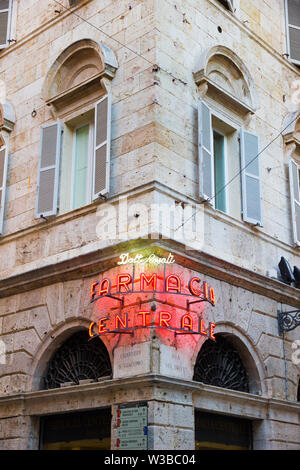 Ascoli Piceno, Italien - Juni 27, 2019: leuchtende Leuchtreklame in der Altstadt Lesungen: 'Doctor Rosati Central Apotheke' bei Sonnenuntergang Stockfoto