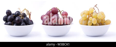 Three white ceramic bowls each containing grape different color and taste Stockfoto