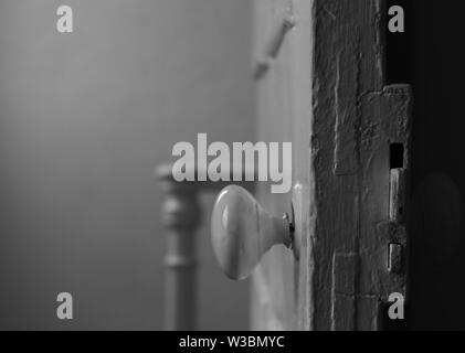 Alte Tür mit zerbrochenen Tür und Treppe Geländer im Hintergrund Stockfoto