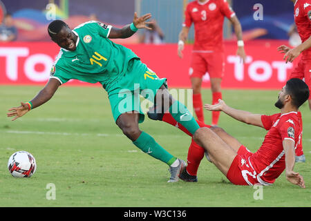 Kairo, Ägypten. 14. Juli, 2019. Der senegalesischen Henri Saivet (L) und der Tunesischen Ferjani Sassi Kampf um den Ball während der 2019 Afrika Cup Halbfinale Fußball Match zwischen Senegal und Tunesien am 30. Juni Stadion. Credit: gehad Hamdy/dpa/Alamy leben Nachrichten Stockfoto