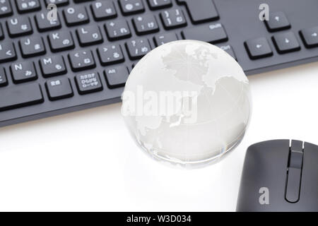 Glas Kugel Kugel mit Tastatur auf weißem Hintergrund Stockfoto