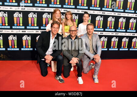 Köln, Deutschland. 13. Juli, 2019. Die Schauspieler Alexandra Petzschmann, Paula Renzler und Lilli Lacher (L-R) vor Thomas Heinze, Jürgen Vogel, Hinnerk Schönemann kommen zur Premiere des Films sterben Drei!!! (Drei Ausrufezeichen) Quelle: Horst Galuschka/dpa/Alamy leben Nachrichten Stockfoto