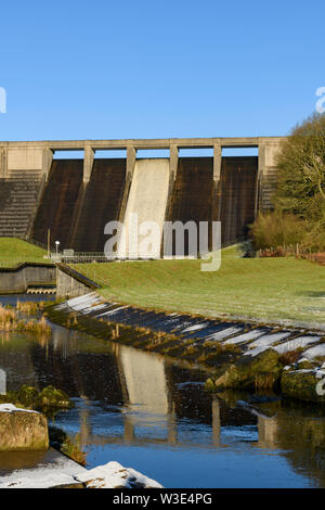 Hohe, steile, konkrete Damm am Thruscross Behälter in das Wasser im Kanal auf frostigen Wintertag (blauer Himmel) - North Yorkshire, England fließende wider, Großbritannien Stockfoto