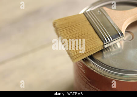 Einen Pinsel liegt auf einem Metall kann auf einem alten White vintage Holzbrett Tabelle. Für Text oder Logo. Stockfoto
