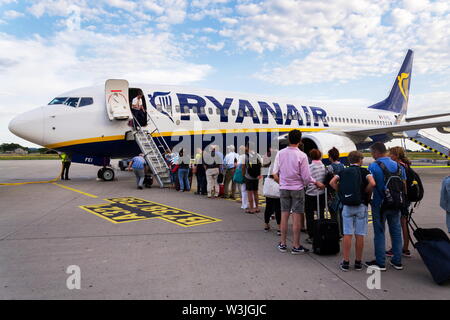 MEMMINGEN, Deutschland - 6. JULI 2019: Menschen boarding Ryanair der Irischen Low-Cost-Airline Flugzeug Boeing 737 mit bewölktem Himmel Hintergrund Am 6. Juli, 2019 in Memmin Stockfoto