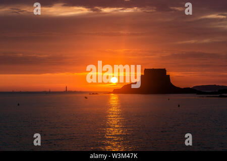 Einen malerischen Sonnenuntergang am Meer über Fort du Petit Bé Bon Secours Strand widerspiegelt, Saint Malo, Bretagne, Frankreich. Stockfoto