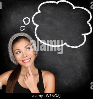 Denken student hipster Frau von Tafel mit dachte bubble Sprechblase. Multirassischen hipster University College Student nachdenklich und Kontemplation am Schwarzen Brett schwarzen Hintergrund. Stockfoto