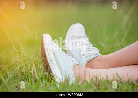 Blaue Turnschuhe im Gras Stockfoto