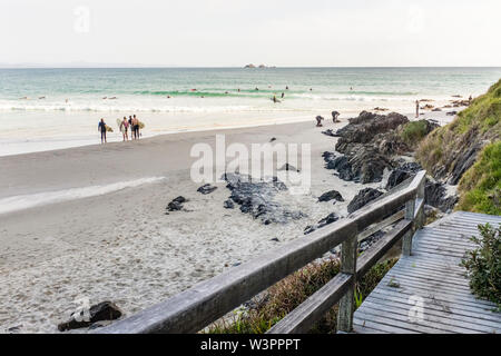 Surfer, die auf dem Land oder im Wasser an Wategos Beach Byron Bay, NSW, Australien Stockfoto