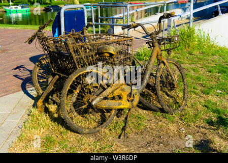 Fahrräder gefischt aus dem Kanal durch die Stadt Reiniger und wollen durch den Papierkorb Sammler abgeholt zu werden, Stockfoto