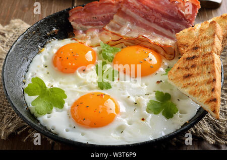 Gebratene Eier, Speck und Toast auf der Pfanne, Ansicht schließen Stockfoto