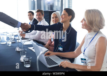 Geschäft Leute die Hände schütteln mit einander bei der Überprüfung der im Business Seminar Stockfoto