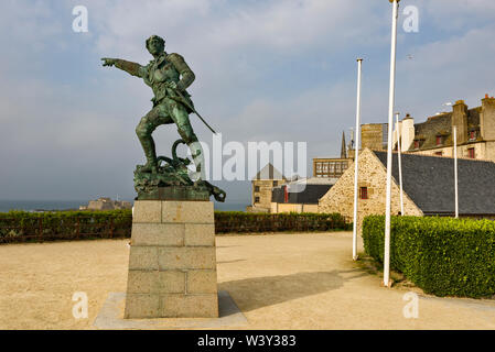 Statue zum Gedenken an Sailor Robert Surcouf, war der französische Privatfahrer mit der ummauerten Stadt im Hintergrund in Saint Malo, Frankreich Stockfoto