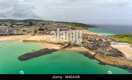 Luftaufnahme über Sandstrände, Fischereihafen, türkisfarbenen Meer, von Cornish Küstenort St Ives, an einem bewölkten Sommertag. Stockfoto