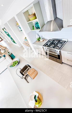 Bunte Küche Design einschließlich aller Einrichtungen, moderne Werkzeuge in der Nähe von Ofen, Spüle verbunden ist, Pantry, keramische Objekte auf dem Tisch. Stockfoto