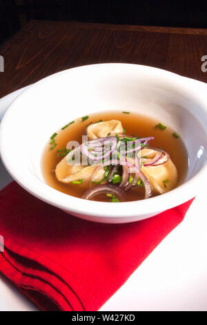 Suppe mit Zwiebeln und Pilze, das warme Essen mit Fleisch und Gemüse, sehr lecker aussehen, Hintergrund ist schwarz, Esstisch für ein Luxushotel oder h Stockfoto