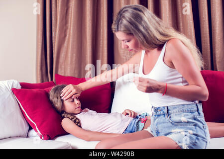 Mutter Temperaturmessung von ihr krankes Kind. Krankes Kind mit hohem Fieber im Bett und Mutter holding Thermometer. Gesundheitswesen und Medizin Konzept Stockfoto
