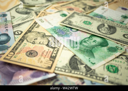 US Dollar stack und Chinesische Yuan Scheine auf den Tisch. Das Konzept der Handelskrieg zwischen den USA und China Stockfoto