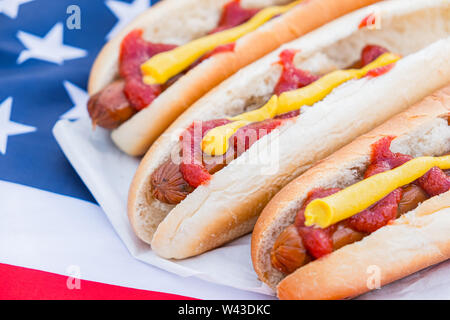 Typisch amerikanisches Fastfood: Hot Dogs und amerikanische Flagge. Nahaufnahme der Stereotypen uns Essen Stockfoto