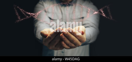 Mann mit DNA-Molekül in der Palme. Innovative Technologien. Mixed Media. Stockfoto