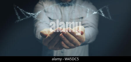 Mann mit DNA-Molekül in der Palme. Innovative Technologien. Mixed Media. Stockfoto