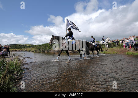 Kelso, Schottland, Großbritannien. Juli 2019 20. Kelso Civic Woche - yetholm Ride Out, Kelso. Kelso Laddie Mark Henderson trägt die Stadt Flagge (Standard), wie Er durchschreitet die Bowmont Wasser vor der 200 starke montiert Kavalkade mit RHM Sean Haken (2018 KL), Craig Logan (2017-KL), auf der Fahrt zu Yetholm Samstag, 20. Juli 2019. (Bild: Rob Grau): Rob Grau/Alamy leben Nachrichten Stockfoto