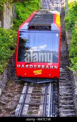 Interlaken, Schweiz - 16. Juli 2019: rote Seilbahn fahren bergab vom Harder Kulm, oben von Interlaken. Die Seilbahn fährt nach oben und unten von Touristen beliebt. Transport, Tourismus. Stockfoto