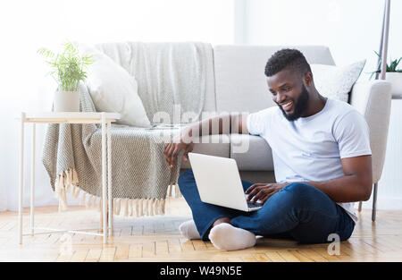 African American guy spielen video game auf Laptop Stockfoto