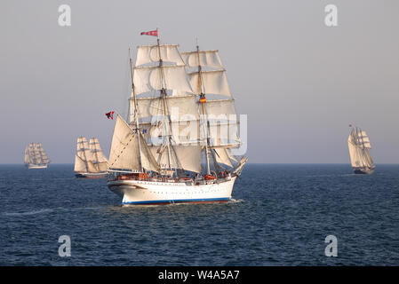 Statsraad Lehmkuhl am Meer in der Abendsonne, die von drei weiteren Schiffen begleitet. Tall Ships Races 2016, Cadiz, Spanien Stockfoto