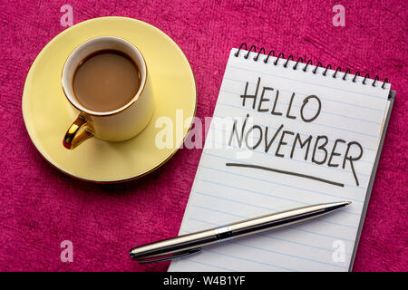 Hallo November - Handschrift in einem Notebook mit einer Tasse Kaffee Stockfoto