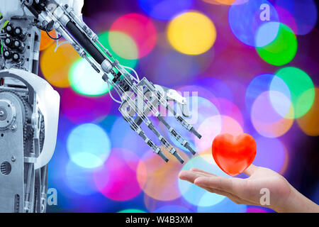 Das Herz des Menschen zur Hand, um eine künstliche Roboter in Valentinstag senden Für die Roboter haben Liebe wie ein Mensch, auf bunten Bokeh verschwommenen Hintergrund Stockfoto