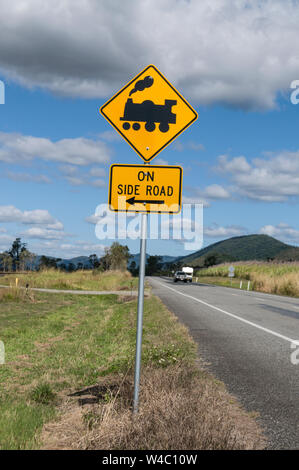 Ein Zucker zug Bahnuebergang Zeichen an einer Hauptstraße in Zuckerrohr Felder in der Umgebung von Mackay, Queensland in Australien. Mackay ist der größte Zucker p Stockfoto