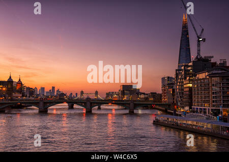 Sonnenaufgang über der City von London, von der Millennium Bridge, London England Großbritannien erfasst Stockfoto