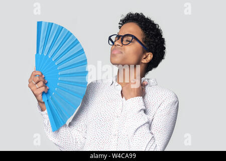 Biracial Mädchen wave mit Handfächer Leiden von Hitze überhitzt Stockfoto