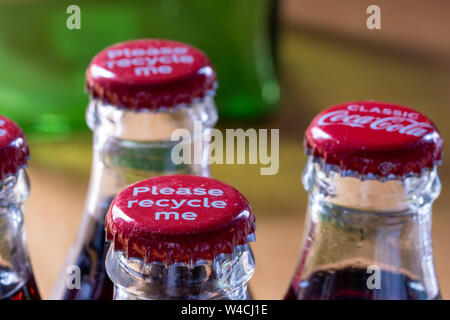 Red Metalle Kappen oben auf Retro Stil Glas Coca Cola Flaschen die Meldung 'Bitte recyceln Sie mich'. Stockfoto