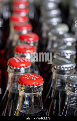 Red Metalle Kappen oben auf Retro Stil Glas Coca Cola Flaschen die Meldung 'Bitte recyceln Sie mich'. Stockfoto