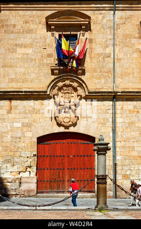 Universität von Salamanca, 1218, UNESCO-Welterbe, alte Sandsteingebäude, höhere Bildung, große Tür aus Holz, Metall, Dekorationen, bunte Fahnen, Uneso Stockfoto