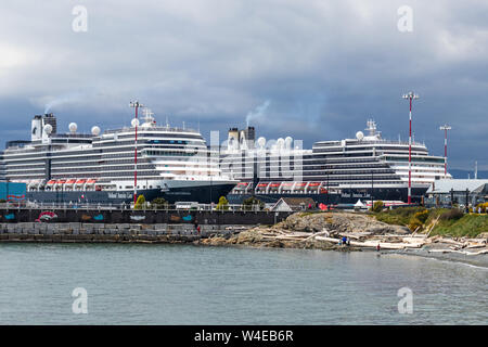 Zwei Kreuzfahrtschiffe der Holland America Line dockten in Victoria, BC an, mit der Breakwater (Meeresmauer), die vor dem Schiff zu sehen war. Stockfoto