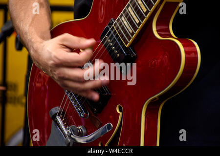 Hände spielen elektrischen Gitarre während der Leistung einer Band mit einem Rock Konzert Stockfoto