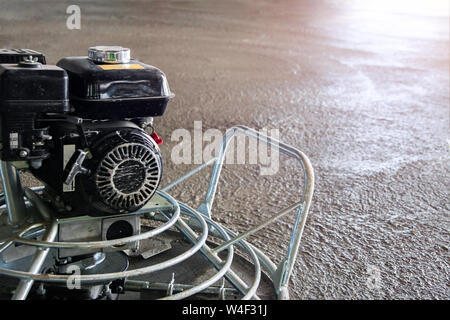 Power float Grinder Maschine auf nassem Beton Hintergrund closeup Shot mit selektiven Fokus und Boke verwischen. Stockfoto