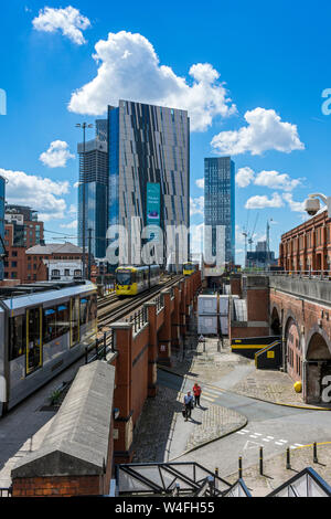 Die Achse Turm und Deansgate Square Apartment Blocks (im Bau) mit einem Metrolink Tram im Vordergrund, Manchester, UK Stockfoto