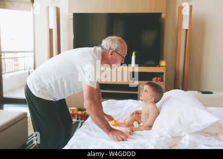 Großvater spielen mit einem Baby zu Hause heraus haften Zunge Stockfoto