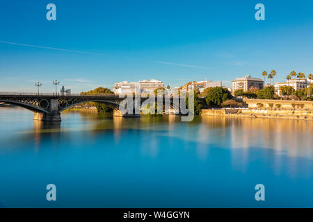 Lange Exposition der Puente de Triana am Fluss Guadalquivir, Sevilla, Spanien Stockfoto