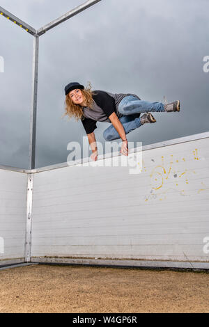 Porträt der jungen Frau über Hindernisse springen Stockfoto